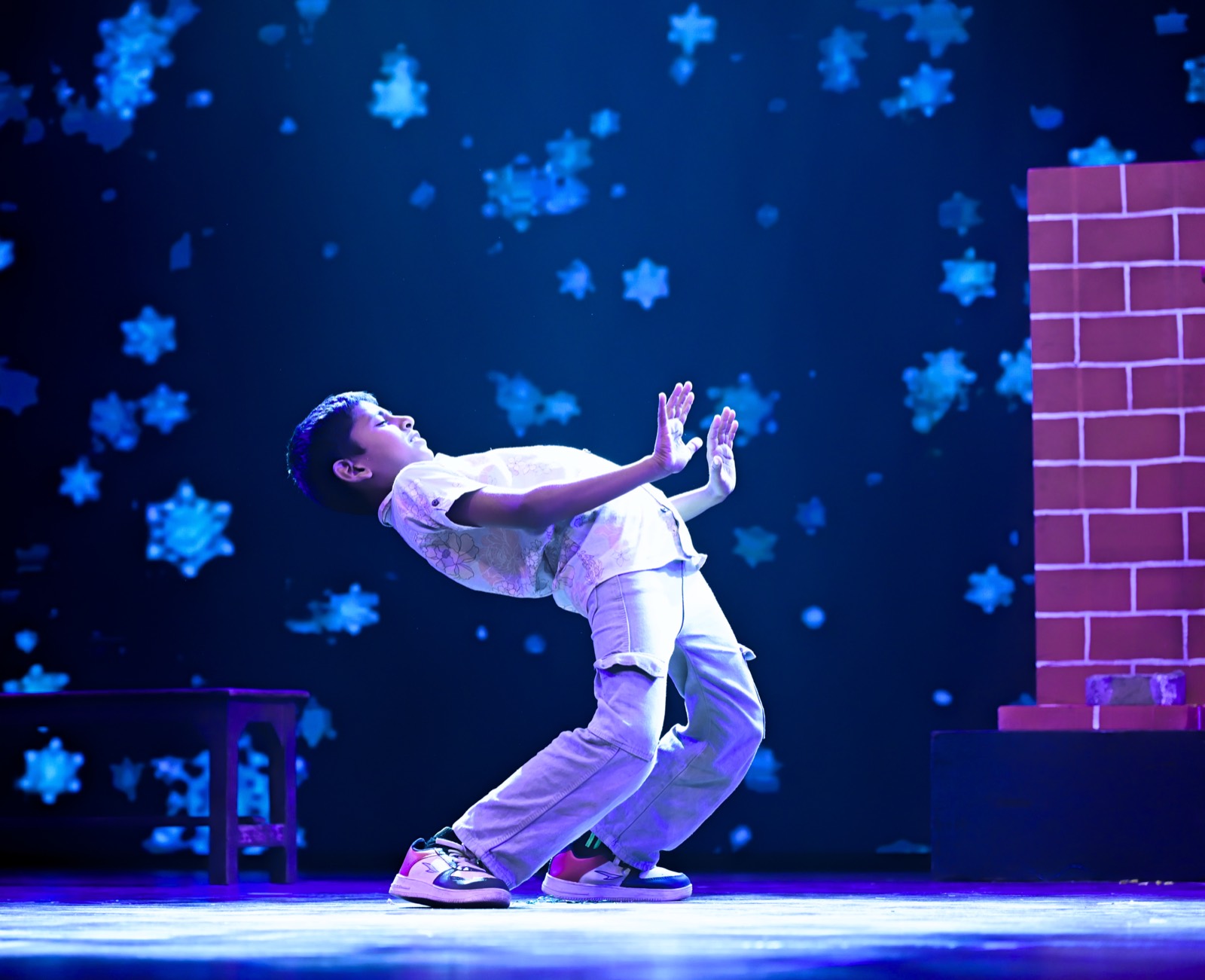 Solo dancer under snowfall projections